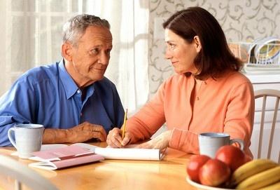 17068 a woman and older man sitting at a table pv